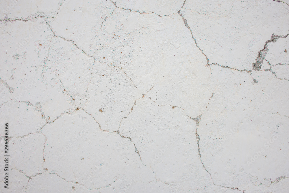 Texture of a white painted wall in cracks Texture of a white painted wall in cracks