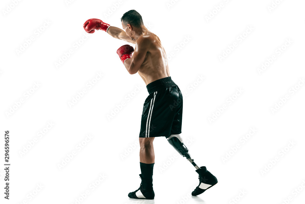 Full length portrait of muscular sportsman with prosthetic leg, copy space. Male boxer in red gloves. Isolated shot on white studio background. Full length portrait of muscular sportsman with prosthetic leg, copy space. Male boxer in red gloves. Isolated shot on white studio background.