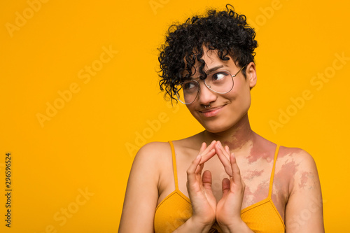 Young african american woman with skin birth mark making up plan in mind, setting up an idea.