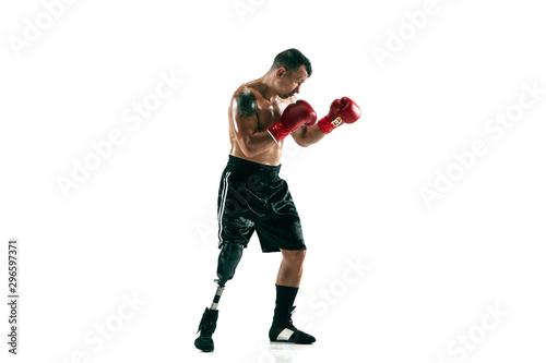Full length portrait of muscular sportsman with prosthetic leg, copy space. Male boxer in red gloves. Isolated shot on white studio background. © master1305