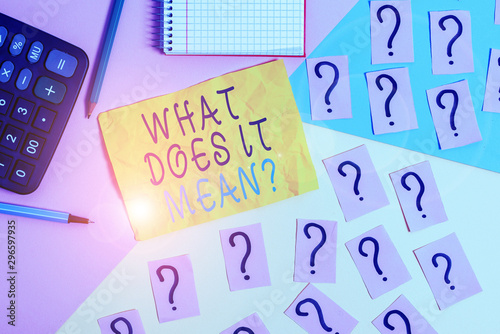 Writing note showing What Does It Mean question. Business concept for intended to communicate unclear statement Mathematics stuff and writing equipment above pastel colours background