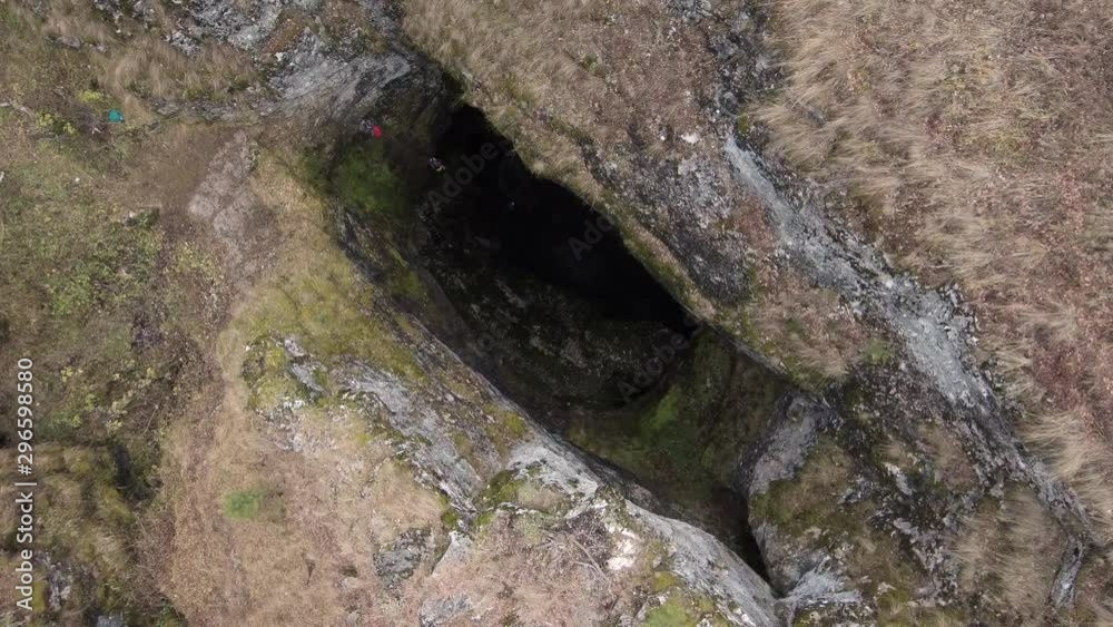 Sumgan-Kutuk karst cave. Descent cavers in the cave. Aerial view. Sumgan-Kutuk karst cave. Descent cavers in the cave. Aerial view.
