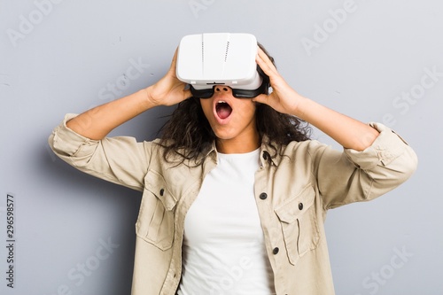 Young african american woman using a virtual reality glasses