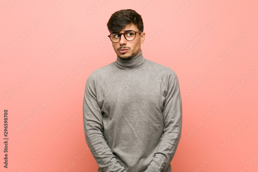 Young smart student man confused, feels doubtful and unsure. Young smart student man confused, feels doubtful and unsure.
