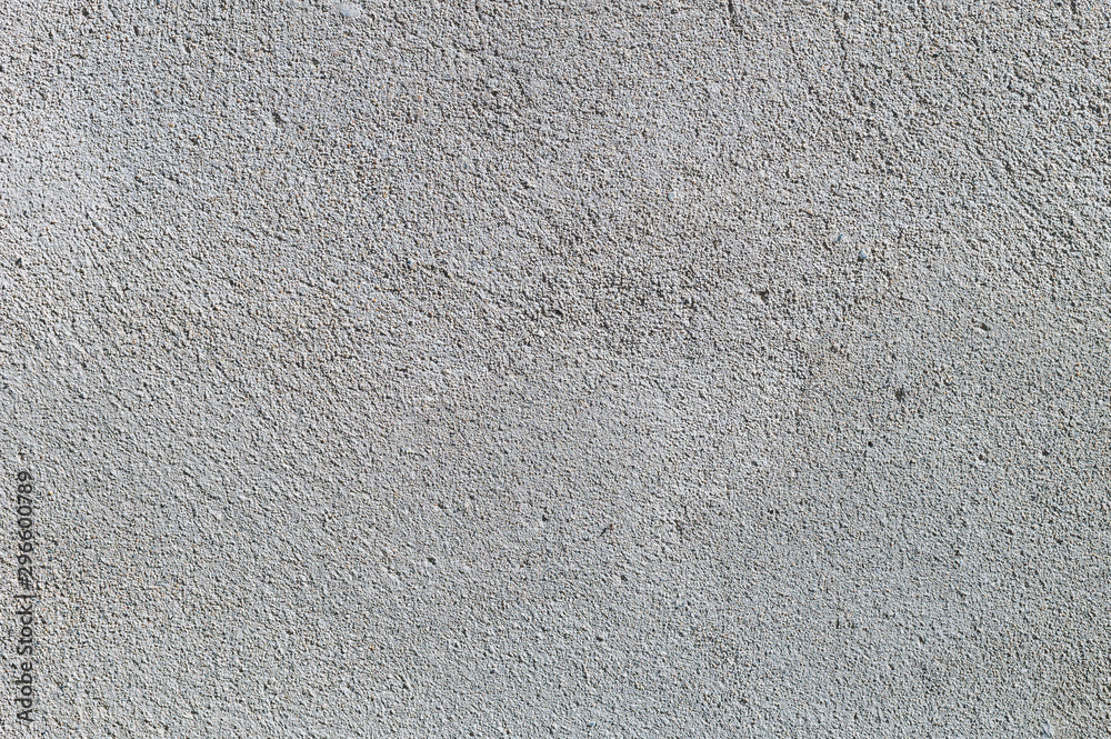 Gray textured cement wall background with fine concrete chips. Construction backgrounds Gray textured cement wall background with fine concrete chips. Construction backgrounds