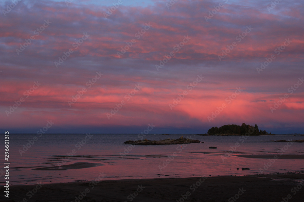 Bright pink clouds over Lake Vanern, Sweden. Sunrise view from Vita Sannar, Mellerud community.