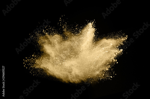 Fototapeta Naklejka Na Ścianę i Meble -  Golden powder explosion on black background. Freeze motion.