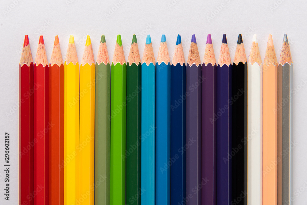 Colored pencils on white paper background Colored pencils on white paper background