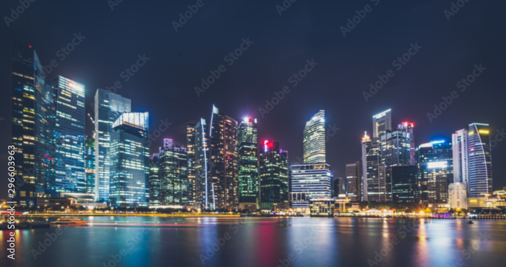 Blured background cityscape at night many tower near lake marsh, swamp at Singapore.