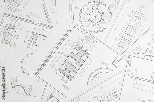 paper engineering drawings of industrial parts and mechanisms