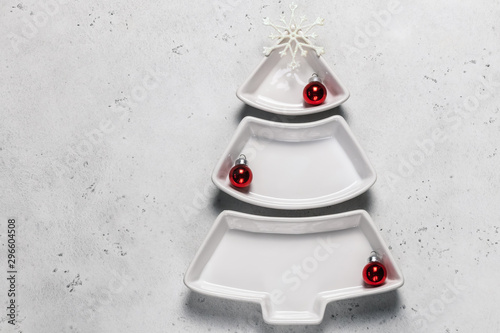 Empty christmas tree shaped plate on cocncrete background.Top view. photo