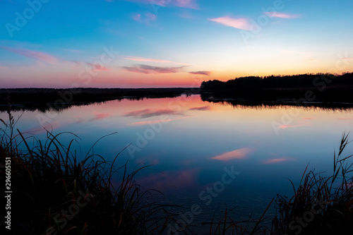 Fototapeta Naklejka Na Ścianę i Meble -  Sunset on the lake. Evening landscape by the lake. purple color photo. Evening lake.
