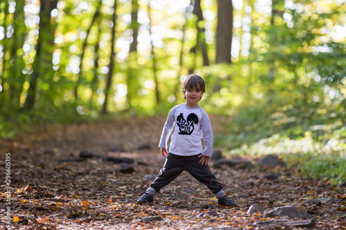 Cute boy in autumn forest