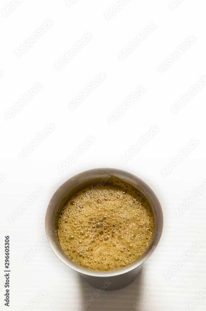 South Indian coffee served in steel glasses - white background with space for text South Indian coffee served in steel glasses - white background with space for text