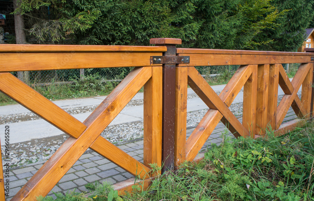 Wooden fence. Yellow square planks of logs. Wooden fence. Yellow square planks of logs.