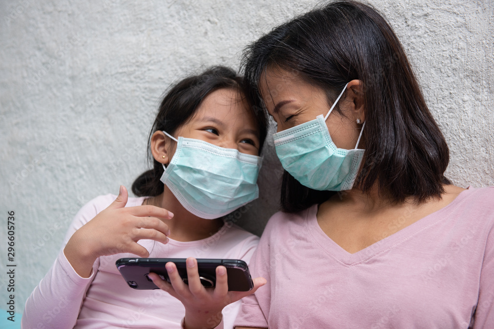 Asian young mother and children daughter wearing protective mask