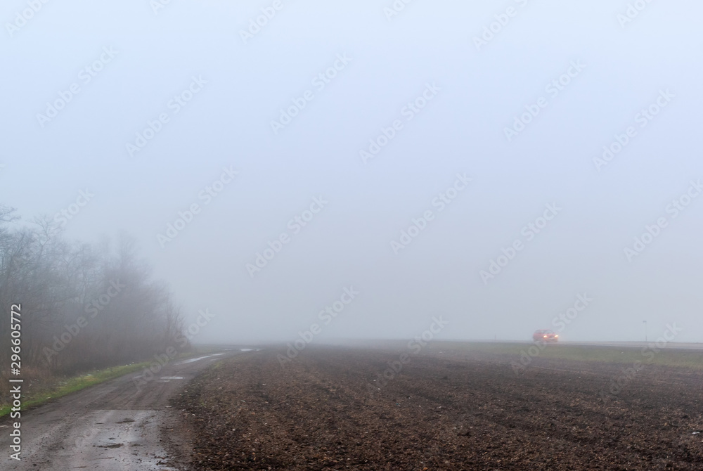 Deep fog on the country road 