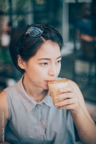Asian woman drinking coffee in vintasg color tone
