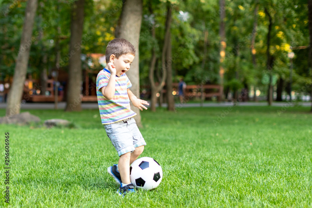 little boy playing football soccer on the field little boy playing football soccer on the field
