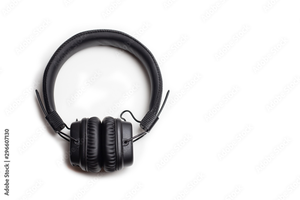 Fototapeta premium Black wireless headphones on a white background, top view