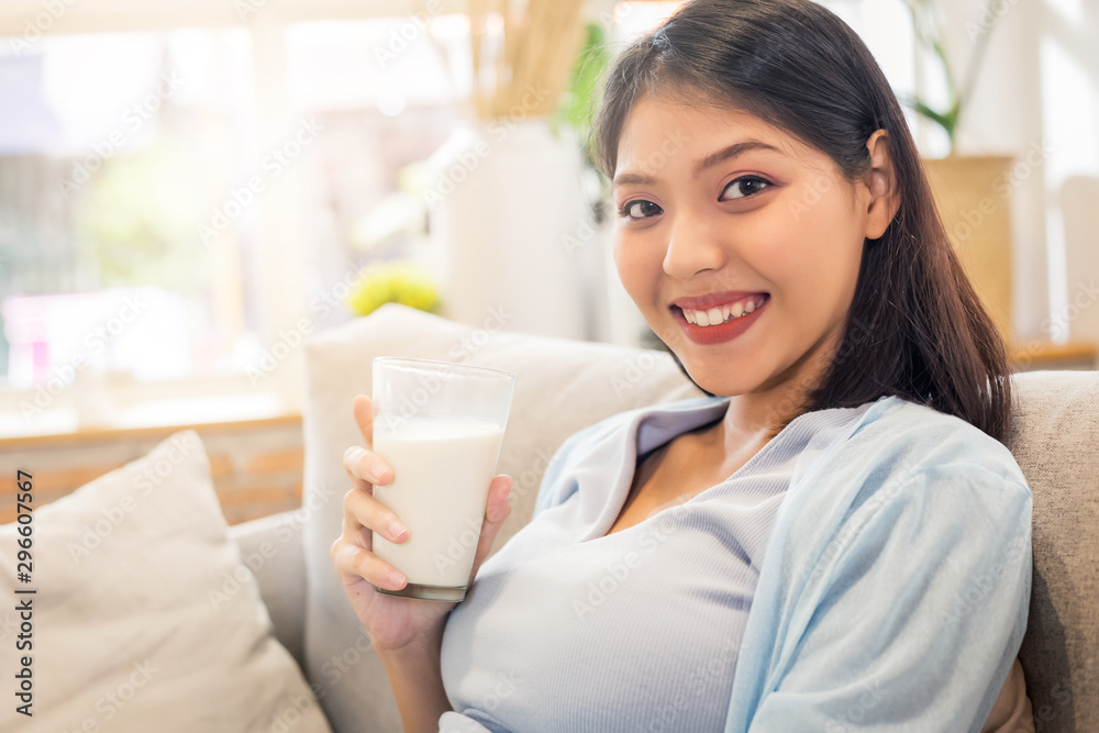 Young beauty happy Asian pregnant woman holding glass of milk drinking healthy drink. Young beauty happy Asian pregnant woman holding glass of milk drinking healthy drink.