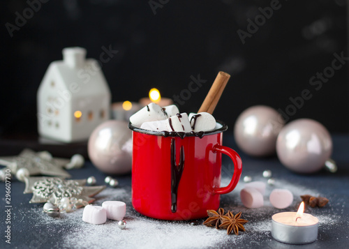 Marshmallow in a red enamel mug with Christmas and New Year decoration. Christmas composition, holiday concept. Copy space