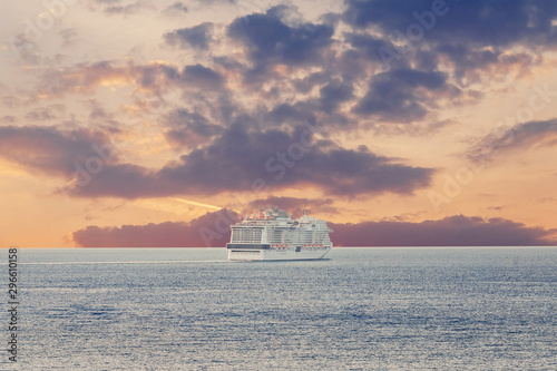 Fototapeta Naklejka Na Ścianę i Meble -  Luxury cruise ship sunset in blue sea with clouds