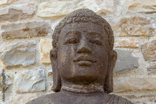 Face of buddha on an old tibetan statue