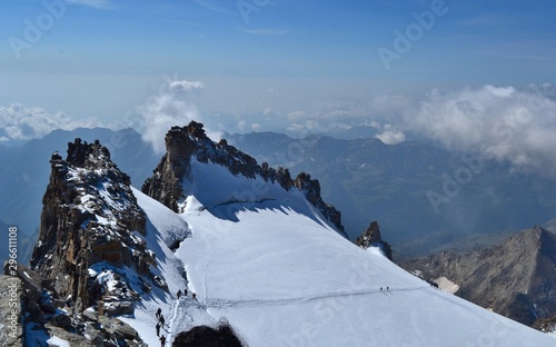 Gran Paradiso National Park, Italy. Climbing to the summit of mount Gran Paradiso 4 061 m with cats and ice ax. Sunny chilly day.