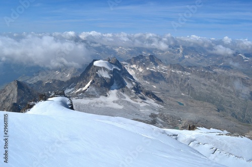 Gran Paradiso National Park, Italy. Climbing to the summit of mount Gran Paradiso 4 061 m with cats and ice ax. Sunny chilly day.