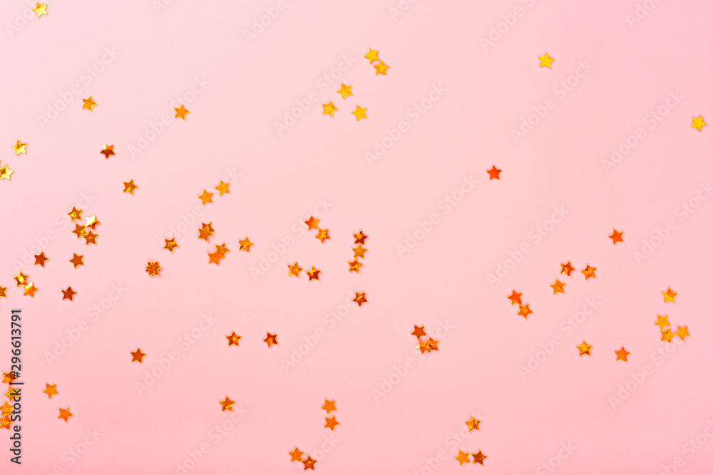 Pink background with golden stars, copy space. Golden stars confetti on pastel background. Pink background with golden stars, copy space. Golden stars confetti on pastel background.