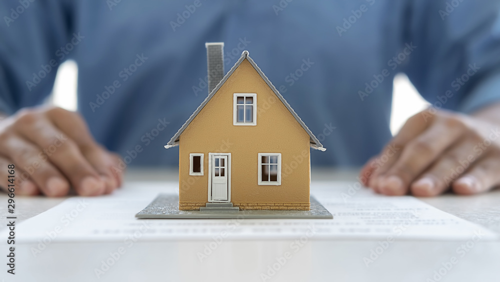House model with agent asking costumer for contract to buy, get insurance or loan real estate or property. House model with agent asking costumer for contract to buy, get insurance or loan real estate or property.