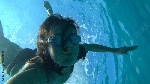 Kekova, Turkey - 30th of September 2019: 4K Woman makes a roll over back underwater photo