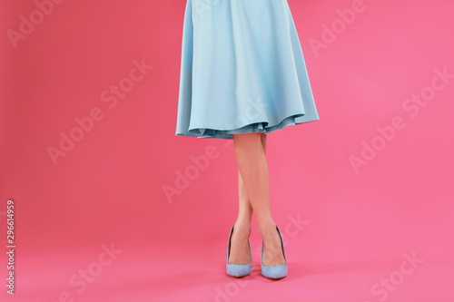 Woman in elegant shoes on pink background