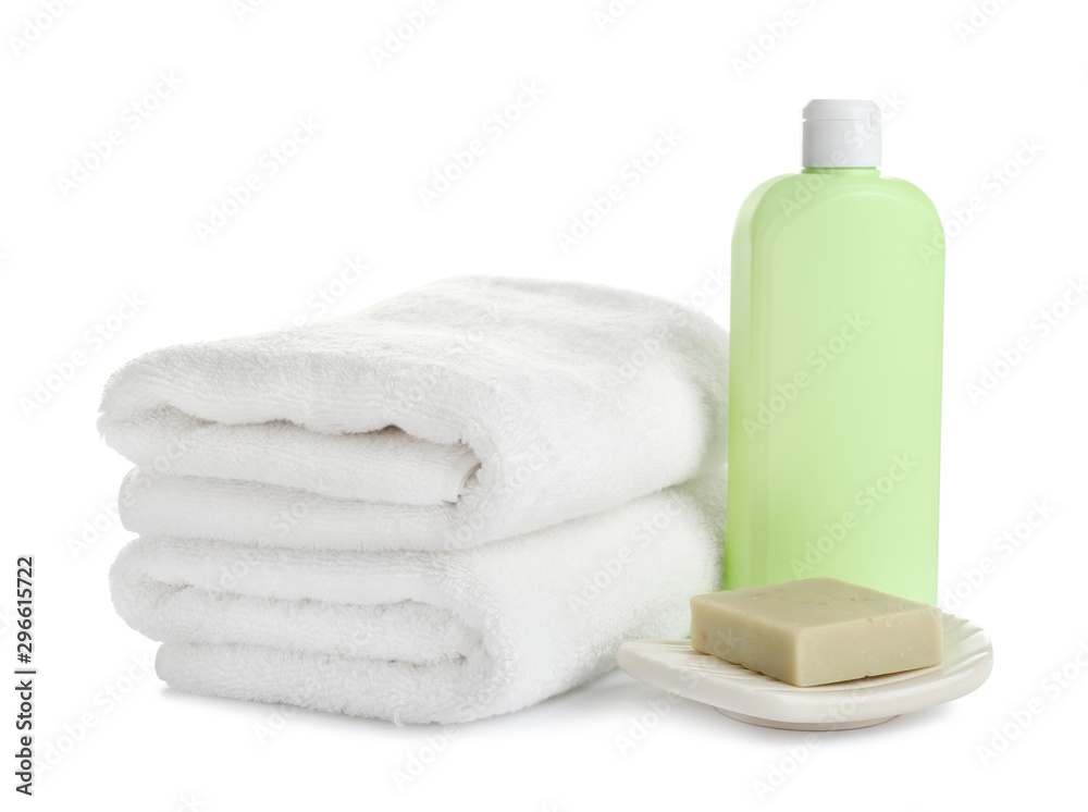 Folded soft towels and toiletries on white background Folded soft towels and toiletries on white background