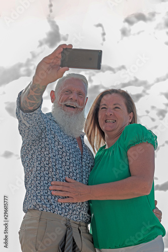 A cheerful mature married couple takes a selfie.