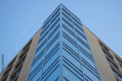 Abstract image of looking up at modern glass and concrete building. Architectural exterior detail of industrial office building. Industrial art and detail.