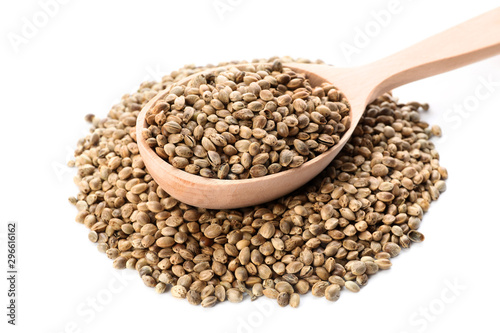Wooden spoon and hemp seeds on white background