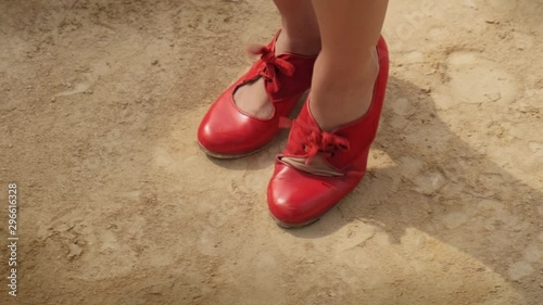 Man and woman dancing flamenco in park. Spanish people and traditional dance in Andalusia, Spain. Dancers performing traditional show in park. Couple and music arts. Detail of female feet and dress