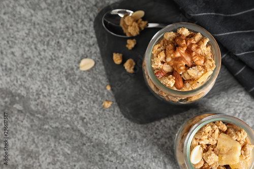 Tasty homemade granola on grey table, flat lay with space for text. Healthy breakfast