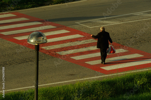 Walker on the red crosswalk, Termoli, Molise, Italy	