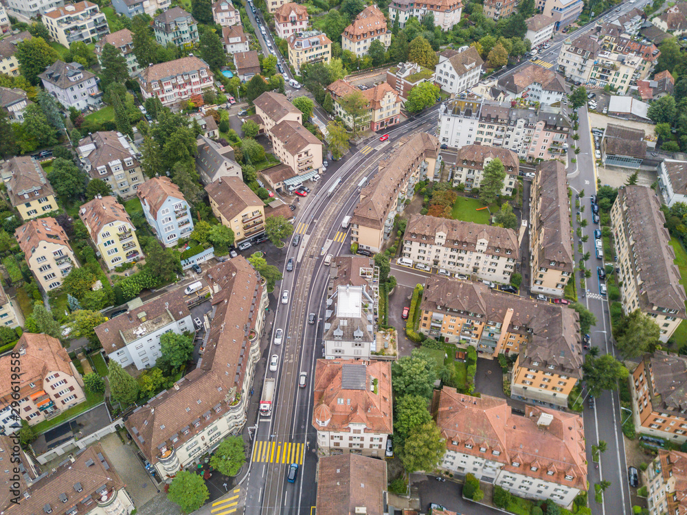 Aerial view of buildings with roofs. Streets with traffic in overhead view. Town in Europe from above..