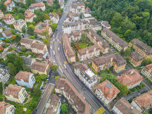 Aerial view of buildings with roofs. Streets with traffic in overhead view. Town in Europe from above..