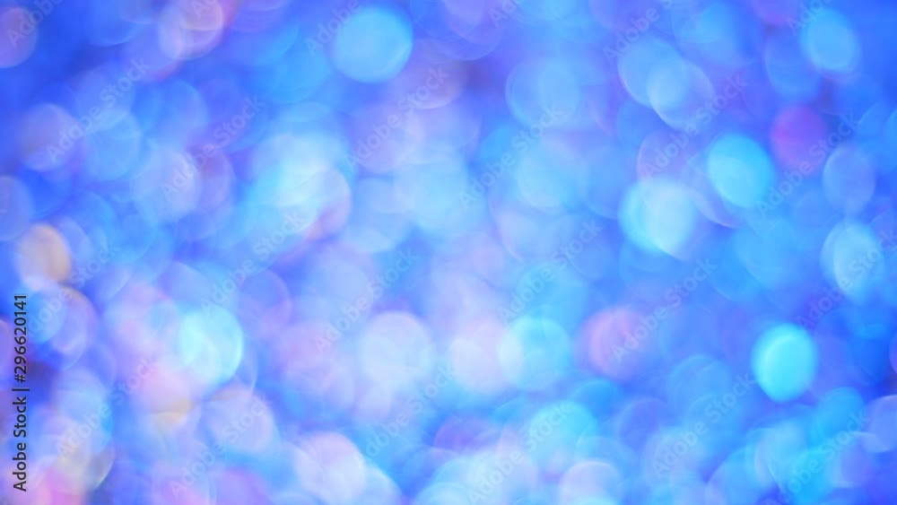 Beautiful bokeh with dynamic neon light. Coffetti shimmer with different colors. Shot from above close-up confetti out of focus. Metallic round confetti glistens in the neon light. Background for Beautiful bokeh with dynamic neon light. Coffetti shimmer with different colors. Shot from above close-up confetti out of focus. Metallic round confetti glistens in the neon light. Background for