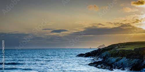a viewpoint from bray head on valentia island in the ring of kerry in the south west coast of ireland during an autumn sunset showing the skellig islands and watchtower
