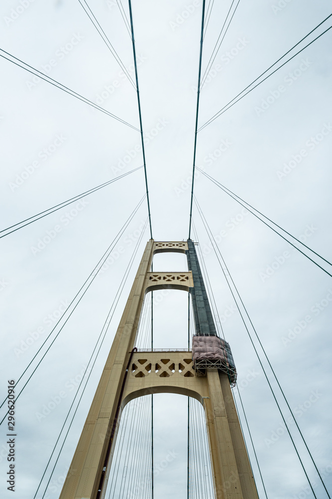 Fototapeta premium The South tower of the Mackinac Bridge being repainted. The bridge spans the Straits of Mackinac between the upper and lower peninsulas of Michigan, USA.