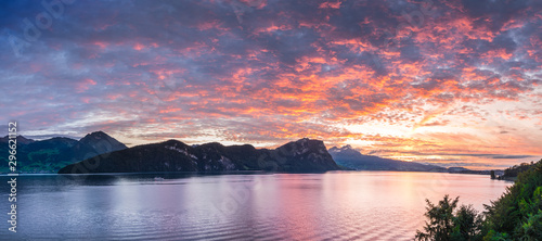 Bright sunset painted the sky red. Switzerland, Alps and Lake Lucerne.
