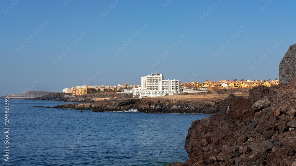Summer, clear vistas towards San Blas and Golf del Sur, popular southern resorts in Tenerife, as seen from Playa Grande, in the small fishermen village of Los Abrigos, Tenerife, Canary Islands, Spain