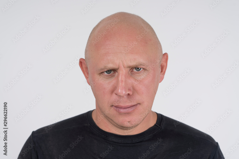 Portrait of an aggressive bald man, close up Portrait of an aggressive bald man, close up