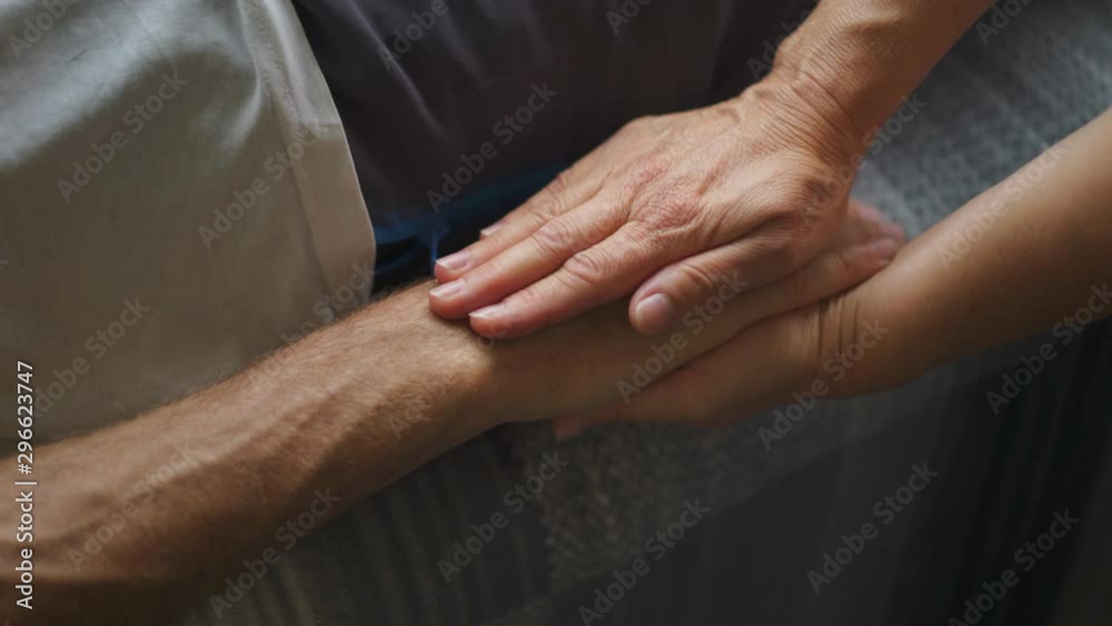 Man lying down and relaxing with reiki holistic therapy treatment by alternative medicine professional therapist. Close Up Shot. Man lying down and relaxing with reiki holistic therapy treatment by alternative medicine professional therapist. Close Up Shot.